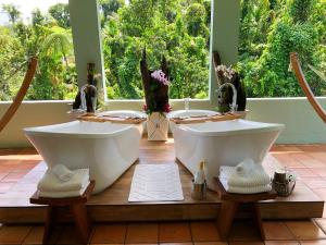 two sinks in a room with two sinksyss at El Yunque Rainforest Inn in Rio Grande