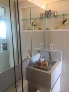 a bathroom with a sink and a toilet at Apartamento Emaús in Parnamirim +10 photos