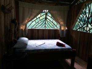 a bedroom with a bed with a large window at El Chontal in Rincón