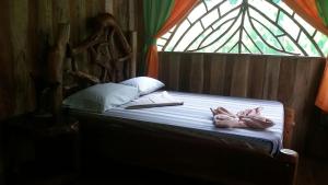 a bed in a room with a stained glass window at El Chontal in Rincón