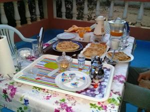a table with a tray of food on it at Azur Tafraout in Tafraoute