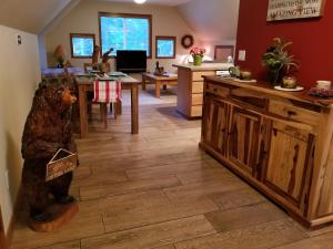 a kitchen with a bear statue in the middle of a room at Cozy Studio Apartment in Greenwater