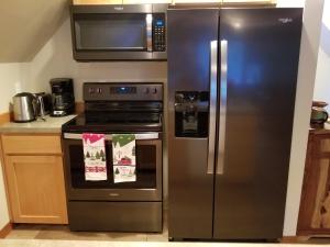 a kitchen with a stainless steel refrigerator and a stove at Cozy Studio Apartment in Greenwater