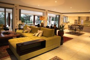 a living room with a couch and a table at Alaya Verde Bed & Breakfast in Ringtail Creek