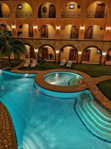 an indoor pool in a building with a swimming pool at Corto del Mar Hotel in Coron