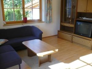 a living room with a couch and a coffee table at Appartement Gasser in Anras