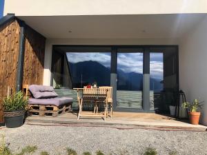 a patio with a chair and a table and a window at Ferienwohnung Koll in Innsbruck