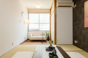 a living room with a couch and a table at Vacational Rental Sunny Heights in Kanazawa
