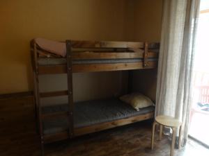 two bunk beds in a room with a chair at New Gudauri Gudauri Palace in Gudauri