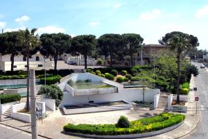 a building with a courtyard with trees and bushes at B&B Vista Gallipoli in Alezio