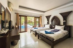 En eller flere senger på et rom på Koh Tao Regal Resort - SHA Plus