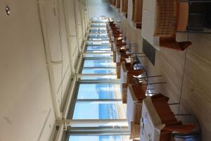 a long hallway with chairs and windows in a building at Hotel Amyclae in Sperlonga