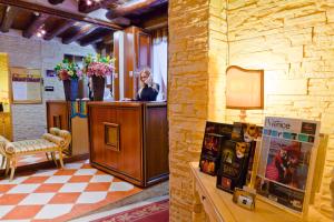 a woman standing at a counter in a salon at Hotel Henry in Venice +26 photos