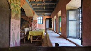 a room with a table and chairs in a building at Kasbah Omari in Tinerhir