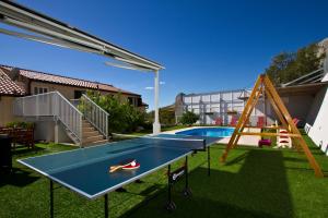 a backyard with a trampoline and a pool at Family apartment in Omiš