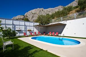 a swimming pool on the side of a building at Family apartment in Omiš