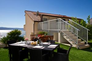 a table in the backyard of a house at Family apartment in Omiš
