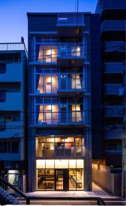 a building with windows and a clock on it at Kamon Hotel Seto in Hiroshima