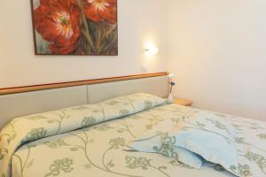 A bed or beds in a room at Savoy Hotel