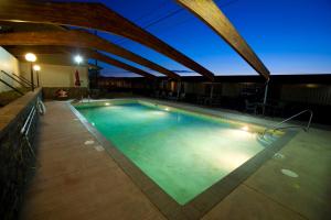 a swimming pool in a hotel at night at Celilo Inn in The Dalles