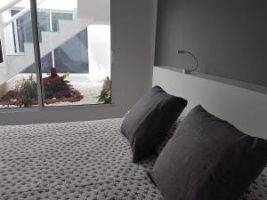 Łóżko lub łóżka w pokoju w obiekcie Vivienda Aries