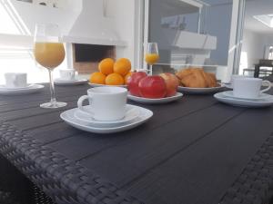 drewniany stół z talerzami owoców i kieliszkami wina w obiekcie Vivienda Aries w Puerto del Carmen