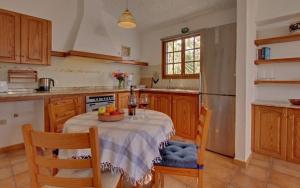 a kitchen with a table with a bowl of fruit on it at Casitas Vista Valle Bajo in El Paso