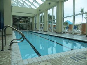 a swimming pool in a building with blue water at Moody Gardens Hotel Spa and Convention Center in Galveston