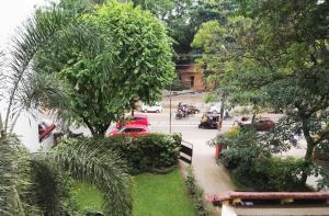 a view of a street with cars and trees at Tagore Homestay Villa Trivandrum in Trivandrum