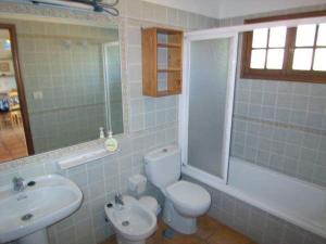 a bathroom with a white toilet and a sink at Casitas Vista Valle Bajo in El Paso +21 photos