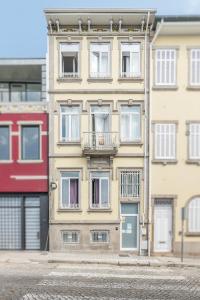 
a large building with windows on the side of it at Antas Ville Guesthouse in Porto
