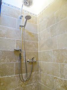 a shower with a shower head in a bathroom at B&B Sarzeau in Sarzeau