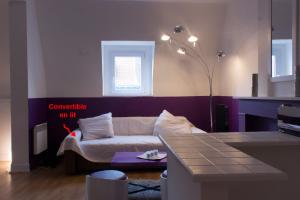 a living room with a couch and a table at Les studios de la grand Place in Tournai