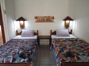 Un pat sau paturi într-o cameră la Rini hotel