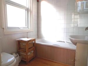 a bathroom with a tub and a toilet and a sink at Arden Guest House in Eastbourne
