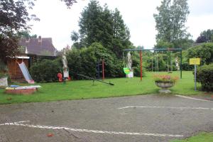 a park with a swing set and a playground at Meyerhof Heiligenrode in Stuhr