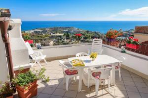 a balcony with a table and chairs and the ocean at Casa Bellavista in Terzorio +26 photos