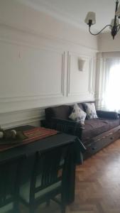 a living room with a couch and a window at Corrientes y Esmeralda in Buenos Aires