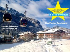 a ski resort with a ski lift in the snow at B&B Cèsa Planber Mountain View in Canazei