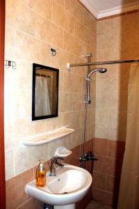 a bathroom with a sink and a shower with a mirror at Baraka Al Aqaba Hotel Suites in Aqaba