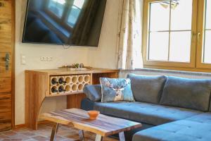 a living room with a couch and a table at Almchalet Pöllatal in Rennweg