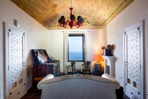 a living room with a couch and a chandelier at Faro Capo Spartivento in Chia