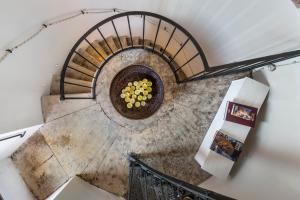 an overhead view of a spiral staircase with grapes at Faro Capo Spartivento in Chia