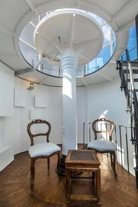 two chairs and a table in a room with a ceiling at Faro Capo Spartivento in Chia