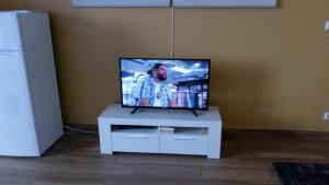 a flat screen tv sitting on top of a white table at Casa do Carvoeiro II-GOOD AND CHEAP!!! in São Vicente