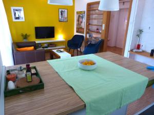 a table with a bowl of fruit on top of it at Feeling good Apartment in Rijeka