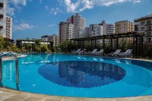 a large blue swimming pool in a city at Upart Home in Mersin