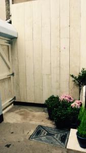 a backyard with a fence and some plants and flowers at Rooms at Martha Jones in Pwllheli