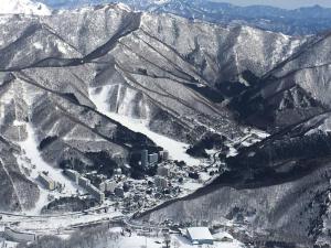 an aerial view of a ski resort in the mountains at Naeba Ski Resort & Fuji Rock in Yuzawa