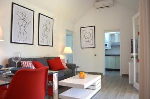 a living room with a couch and a table at The Peaches Bungalows 45 & 46 in Maspalomas